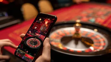 A cheerful woman in traditional clothing using her smartphone during a festive moment, showing how easily the PK7 app fits into everyday life.