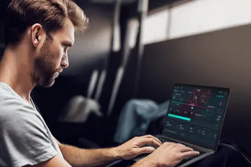 A professional dealer in a tuxedo greeting players at the roulette table, symbolizing the authentic live casino feel at PK7.