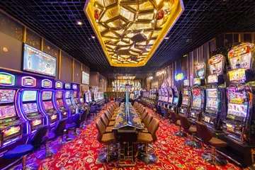 A close-up shot of golden coins falling around a spinning roulette wheel, representing immersive casino action at PK7.
